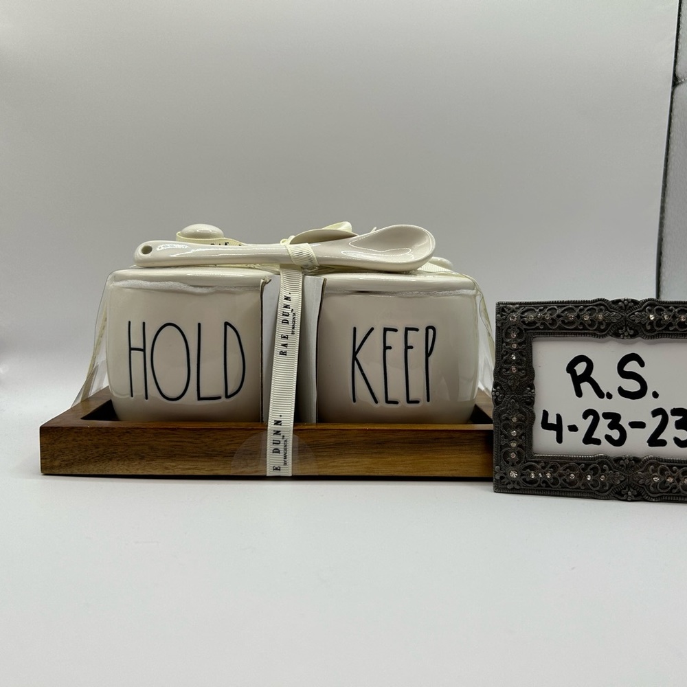 Rae Dunn “Hold” and “Keep” jars with lids, spoons, and wooden tray.